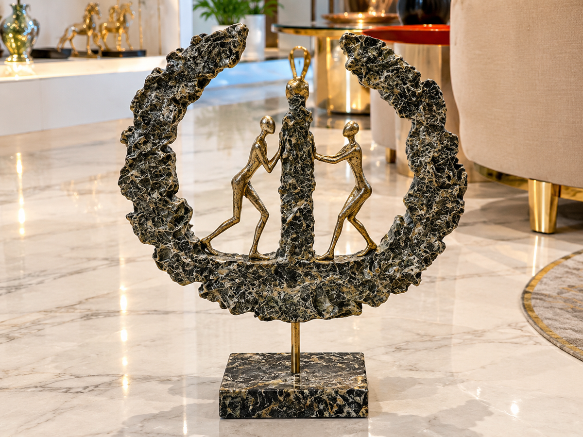 modern abstract teamwork sculpture mounted on a polished marble pedestal.