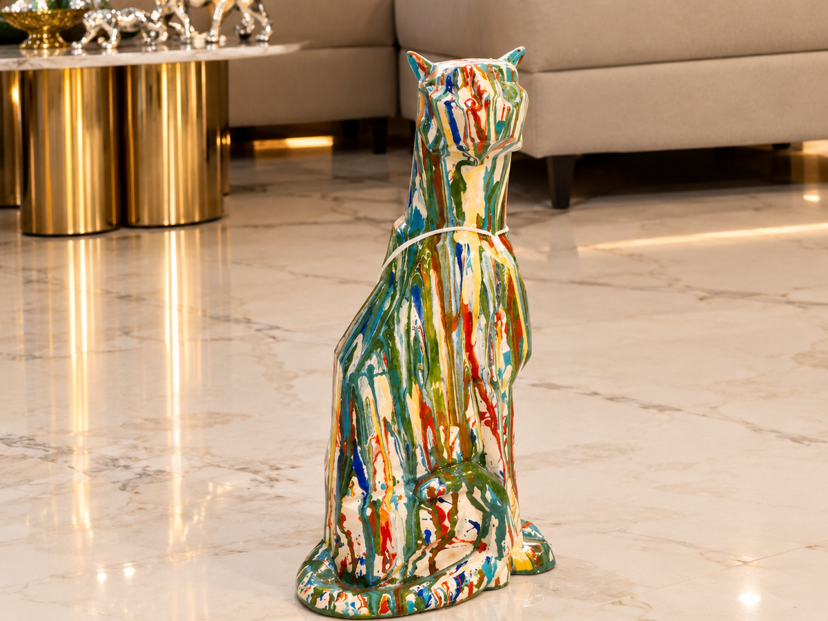 large modern sitting leopard sculpture finished in a vibrant, multi-colored drip-paint pop art style.