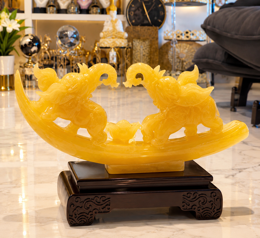 translucent yellow faux-jade resin sculpture featuring two facing elephants